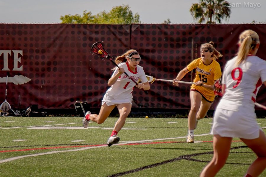 Natalie Peel drives the ball up field during the Aztecs 14-13 victory over Arizona State on Feb. 17 at the Aztec Lacrosse Field. 