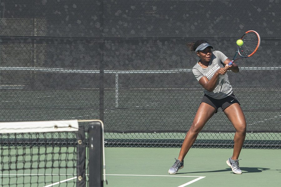 Freshman+Nnena+Nadozie+hits+the+ball+during+a+home+doubles+match+against+USD+on+Feb.+11.+The+Aztecs+lost+the+overall+match+by+a+score+of+4-2.+