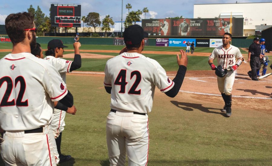Junior catcher Dean Nevarez heads back to the dugout to celebrate with his teammates after hitting a home run during the Aztecs 3-2 victory over Air Force on March 11 at Tony Gwynn Stadium. 
