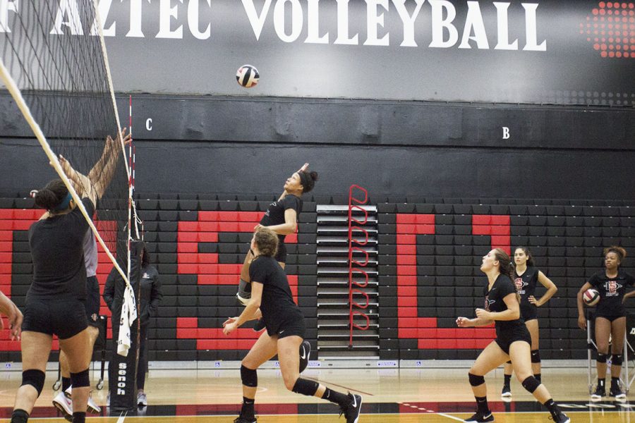 Senior Deja Harris goes up for a spike during practice at Peterson Gym on Aug. 21.