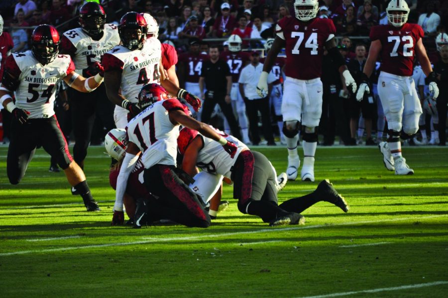 Junior+cornerback+Ron+Smith+%2817%29+and+sophomore+linebacker+Andrew+Aleki+tackle+Stanford+senior+wide+receiver+Trenton+Irwin+following+a+catch+during+the+Aztecs+31-10+loss+to+Stanford+on+Aug.+31+at+Stanford+Stadium.+