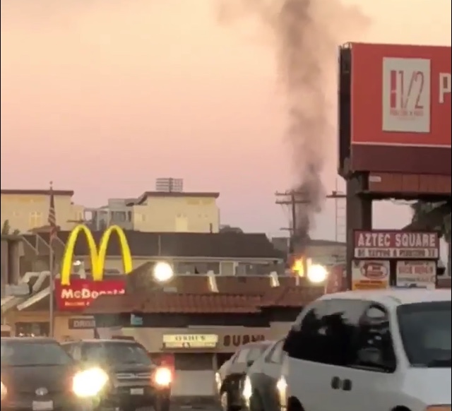 Smoke and flames rise from the SDSU-area McDonald's Friday morning.
