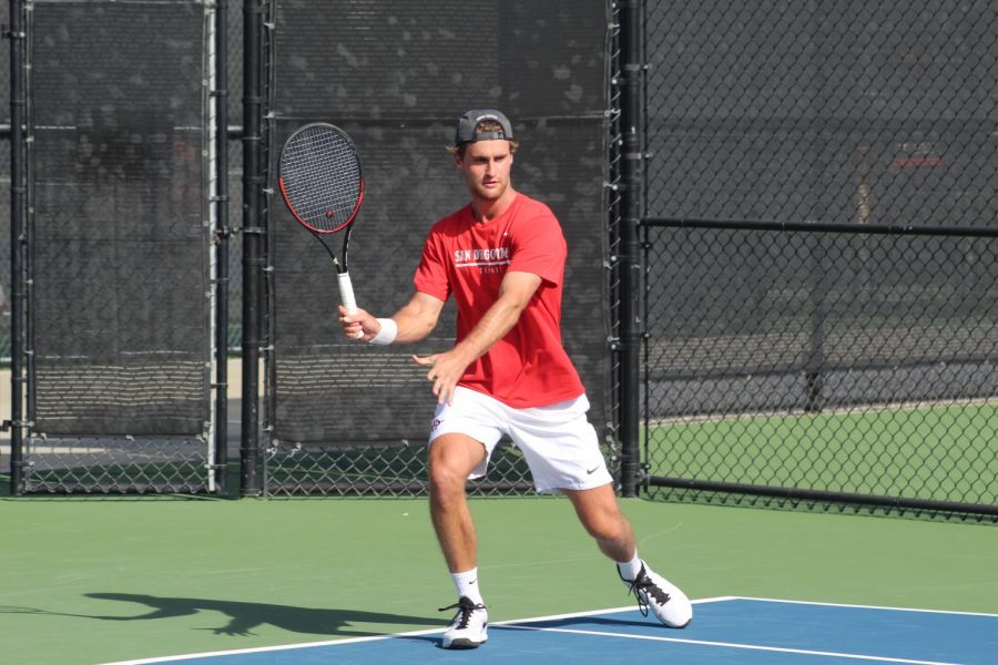 Senior Sander Gjoels-Anderson prepares to swing his racket during his singles match against Mateusz Smolicki. Gjoels-Anderson win helped the Aztecs defeated UC Irvine, 4-3, at the Aztec Tennis Center on Jan. 26. 