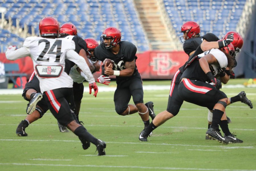 Sophomore running back Kaegun Williams runs through the defense during the Aztecs scrimmage at the annual Fan Fest on Aug. 17 at SDCCU Stadium. 