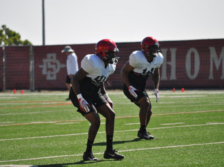 Senior cornerback Sammy Morrison (left) and junior safety Tariq Thompson (right) drop back in coverage during a fall practice at the SDSU Practice Field.