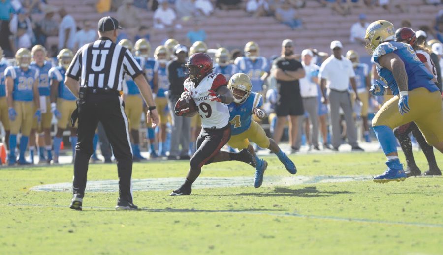 Senior running back Juwan Washington carries the ball during the Aztecs’ 23-14 victory over UCLA on Sept. 7 at the Rose Bowl in Pasadena.