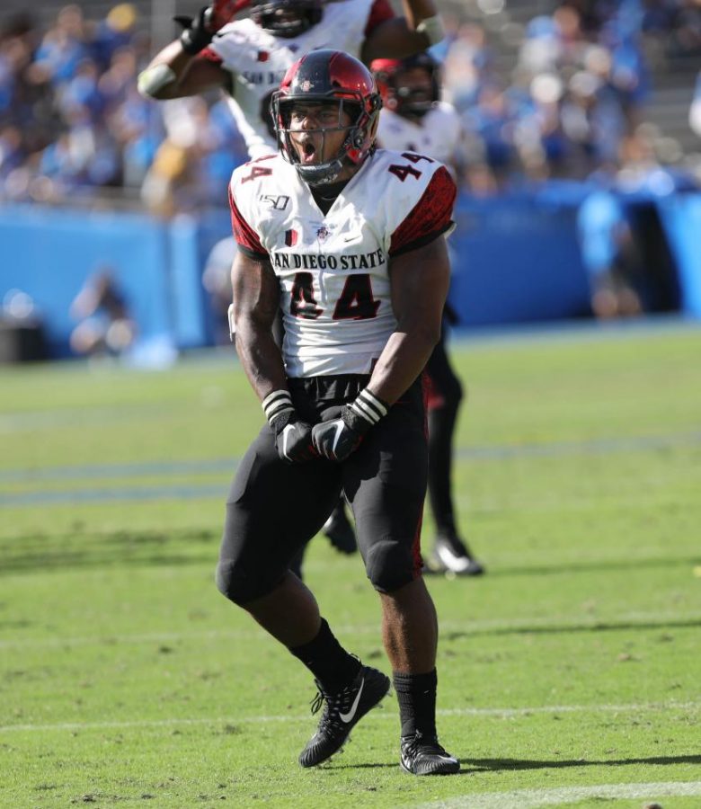 Senior linebacker Kyahva Tezino celebrates a tackle for loss during the Aztecs’ 23-14 victory over UCLA on Sept. 7 at the Rose Bowl in Pasadena. 