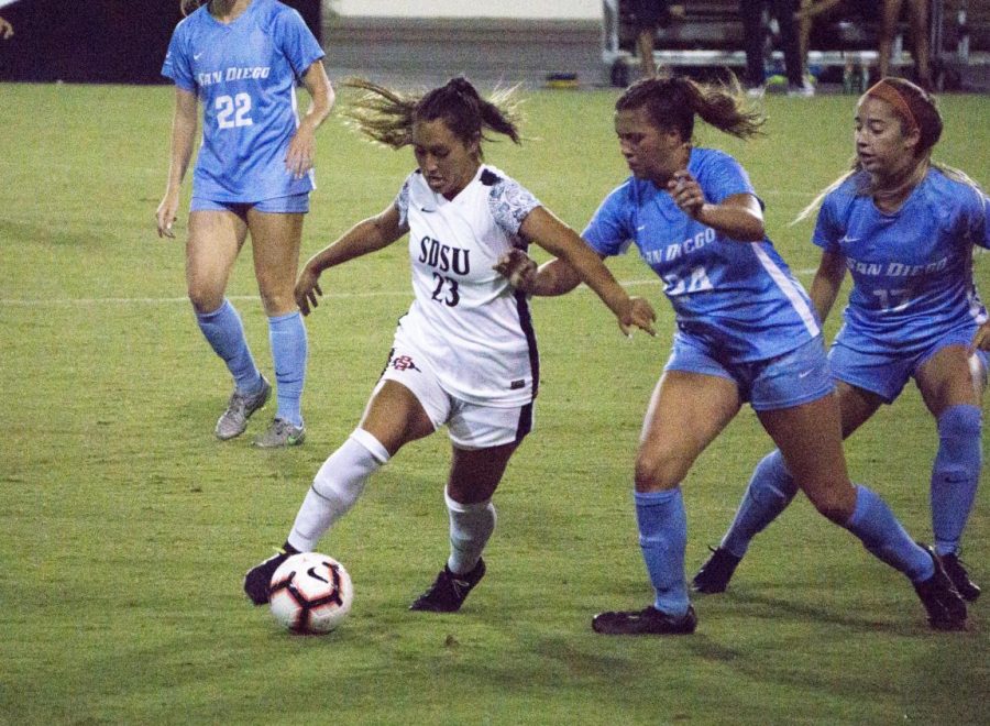 Junior forward Veronica Avalos attempts to keep possession away from the USD defenders during the Aztecs’ 1-0 loss on Sept. 13 at the SDSU Sports Deck.