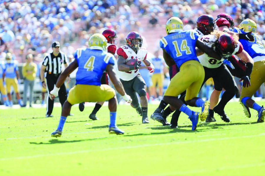 Senior running back Juwan Washington looks to run the ball upfield in the Aztecs 23-14 win over UCLA on Sept. 7 at the Rose Bowl in Pasadena, Calif.