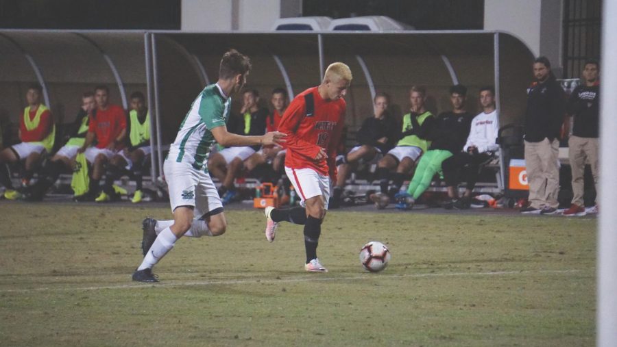Sophomore midfielder Tristan Weber (19) attempts to dribble the ball past the Marshall defender during the Aztecs’ 5-1 loss to Marshall on Oct. 18 at the SDSU Sports Deck.