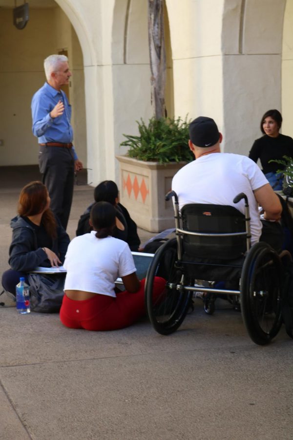 Biology professor Chris Glembotski meets with his students outside Student Services East due to a campus power outage on Nov. 12.