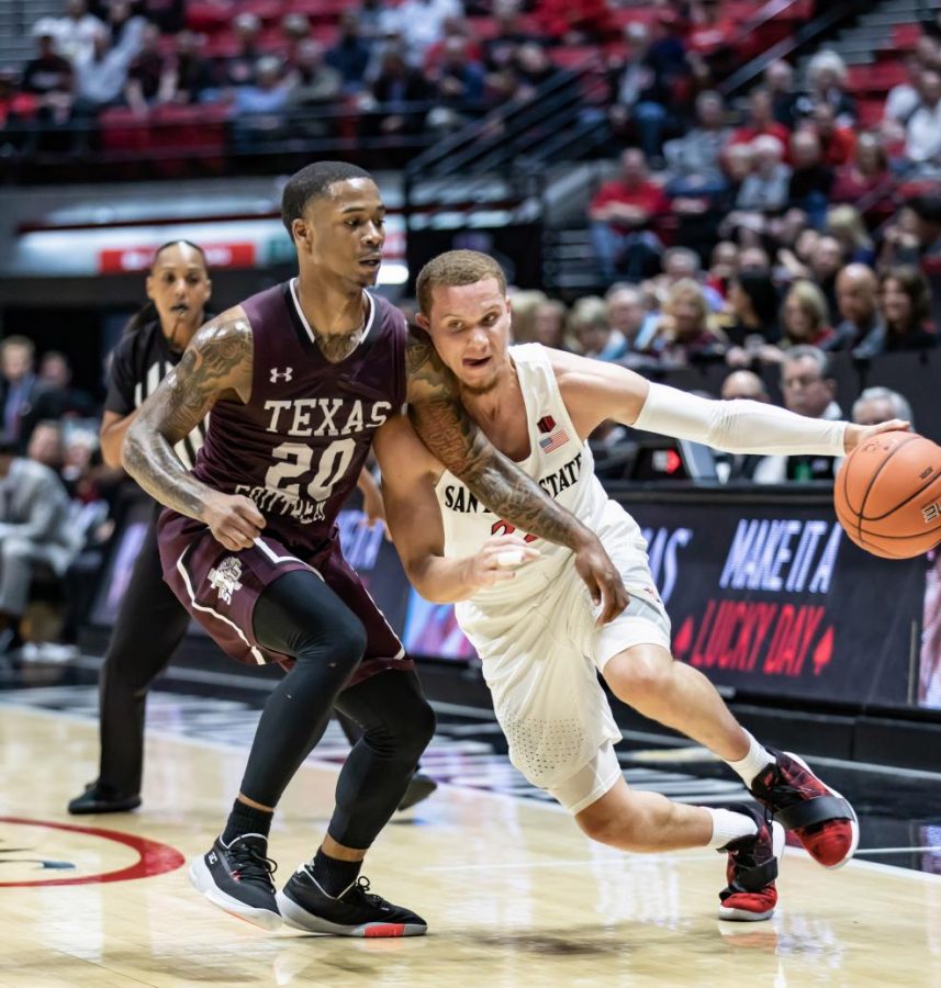 Junior guard Malachi Flynn attempts to dribble past the Texas Southern defender during the Aztecs 77-42 victory on Nov. 5 at Viejas Arena.