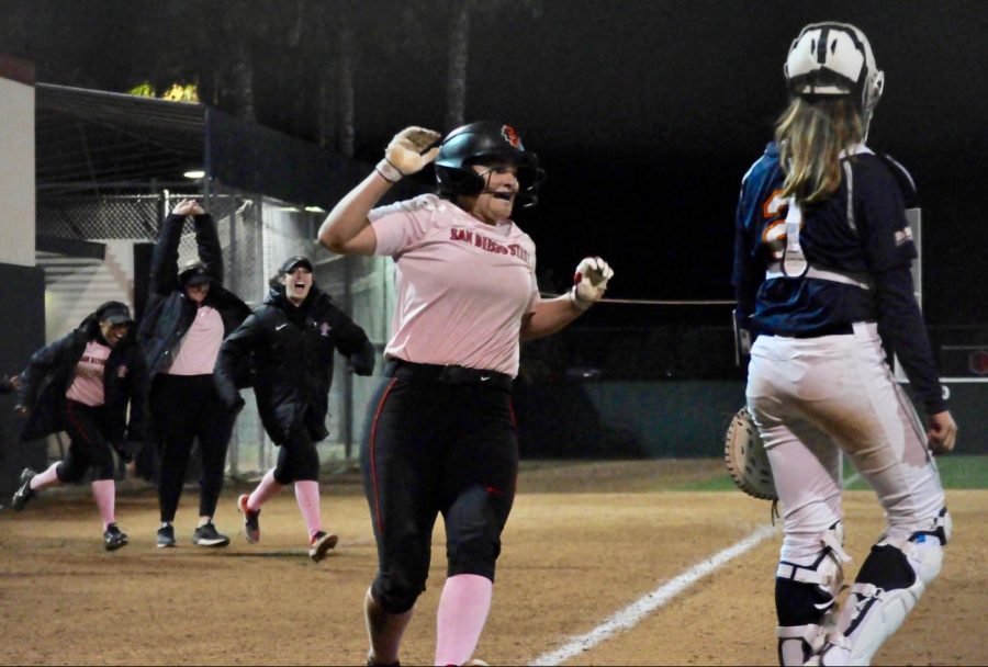 Junior+outfielder+Alexa+Schultz+celebrates+as+she+scored+the+walk-off+run+to+give+SDSU+the+3-2+victory+in+the+eighth+inning+against+Cal+State+Fullerton+on+Feb.+14+at+SDSU+Softball+Stadium.