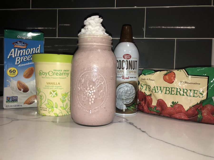 The ingredients and final product for the vegan strawberry milkshake.