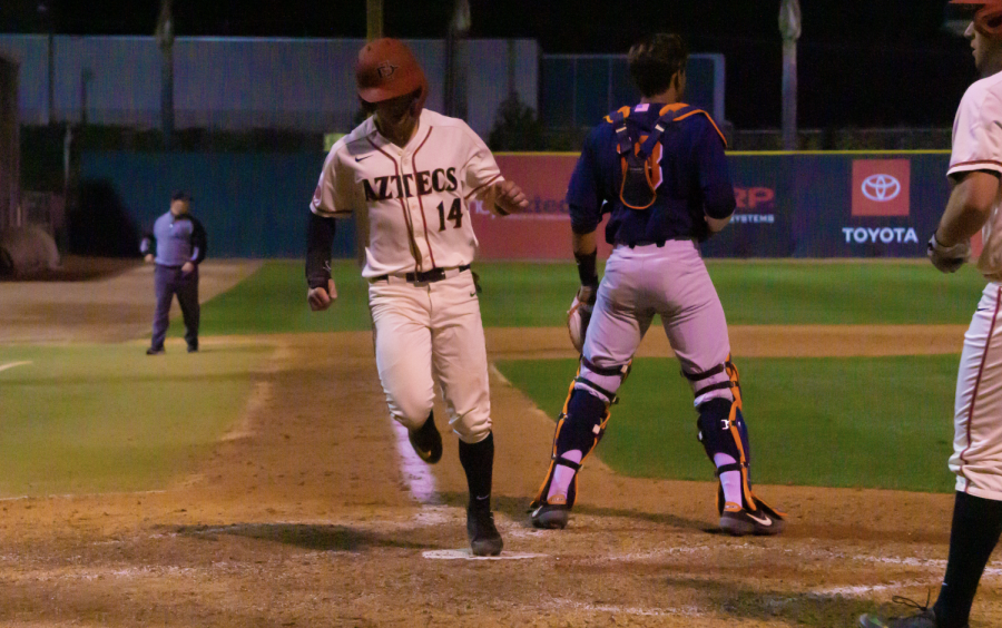 Senior outfielder Mike Jarvis scores during the Aztecs 8-4 win over Cal State Fullerton on Feb. 18 at Tony Gwynn Stadium.