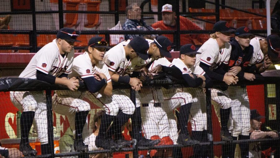 San Diego State baseball players look towards the field from the dugout during the Aztecs 4-1 win over Iowa on Feb. 21, 2020 at Tony Gwynn Stadium.