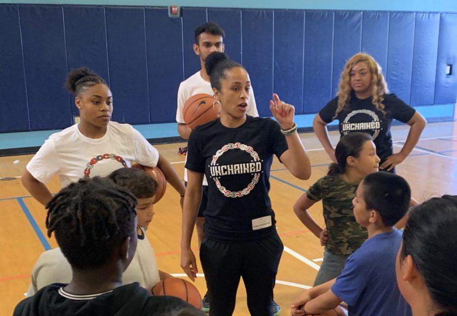 San Diego State women's basketball assistant coach Ciara Carl instructs kids during an Unchained event.