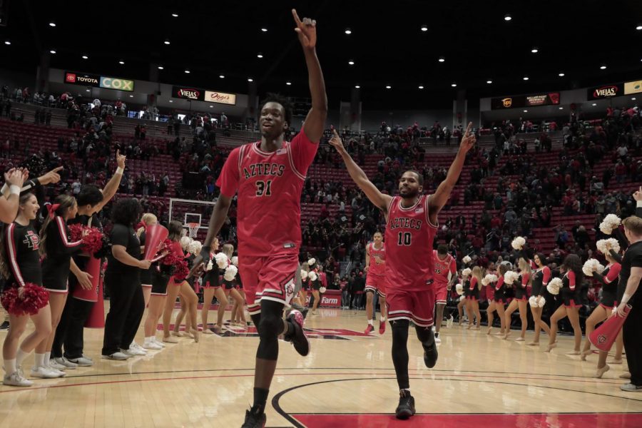 Sophomore forward Nathan Mensah (left) and senior guard KJ Feagin (right) head back to their locker room after defeating San José State 59-57 on Dec. 9 at Viejas Arena.