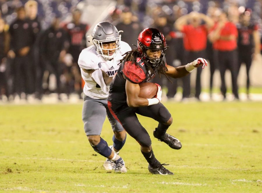 Then-sophomore+wide+receiver+BJ+Busbee+attempts+to+escape+a+Nevada+tackler+during+the+Aztecs+17-13+loss+to+the+Wolf+Pack+on+Nov.+9%2C+2019+at+SDCCU+Stadium.