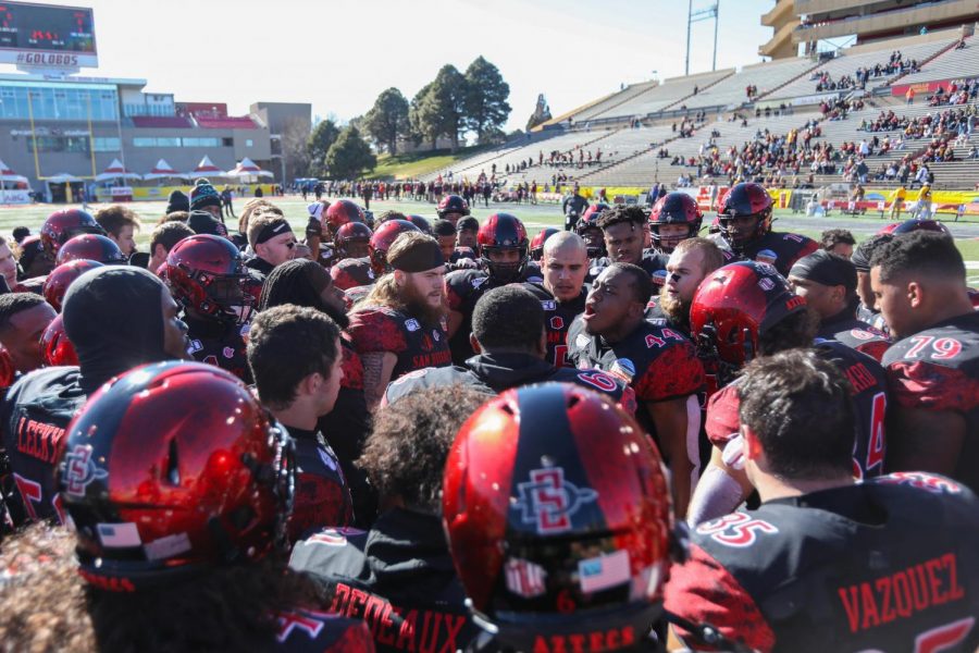 The San Diego State football team huddles around then-senior linebacker Kyahva Tezino as he gives a pregame speech. The game resulted in a 48-11 win over Central Michigan on Dec. 21, 2019 at the New Mexico Bowl in Albuquerque.