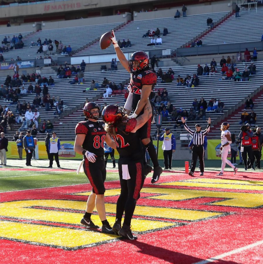 Then-junior running back Chase Jasmin celebrates in the end zone by holding the ball in the air after scoring a touchdown during the Aztecs 48-11 win over Central Michigan on Dec. 21, 2019 at the New Mexico Bowl in Albuquerque, New Mexico.
