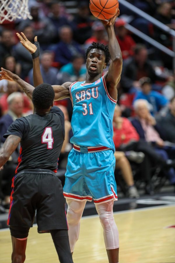 Then-sophomore forward Nathan Mensah attempts a one-handed shot over a Tennessee State defender during the Aztecs 62-49 win over the Tigers on Nov. 25, 2019 at Viejas Arena.