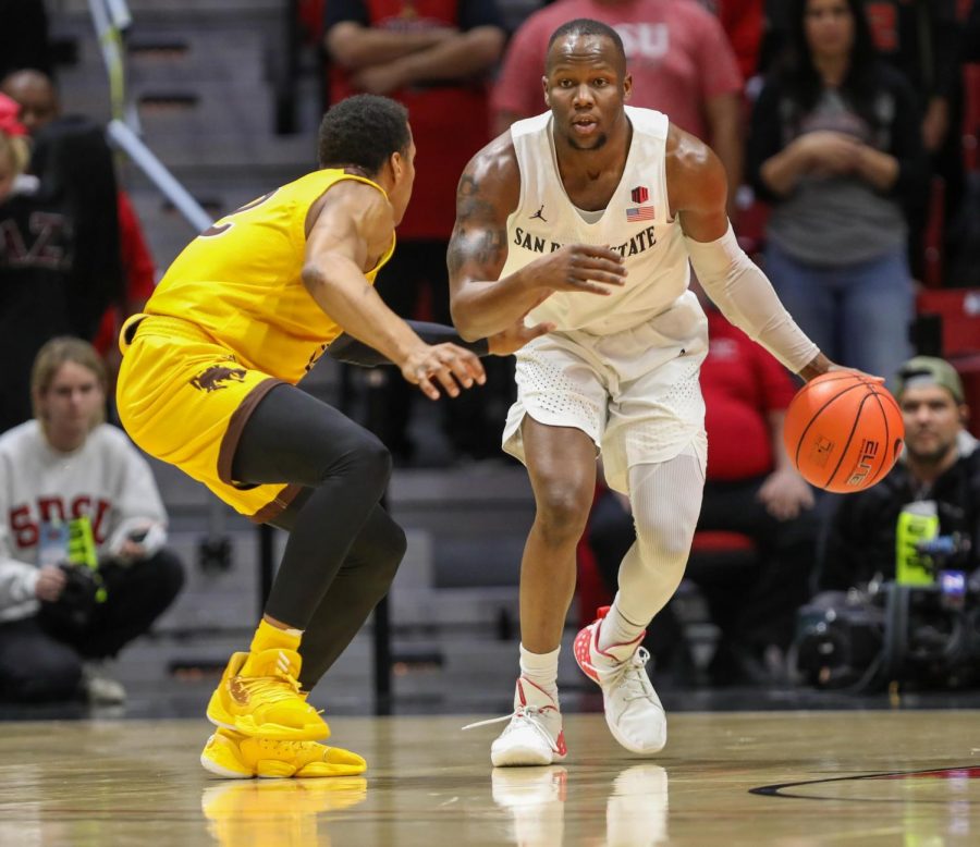 Then-sophomore guard Adam Seiko looks to dribble past a Wyoming defender during the Aztecs' 72-55 win over the Cowboys on Jan. 21 at Viejas Arena.