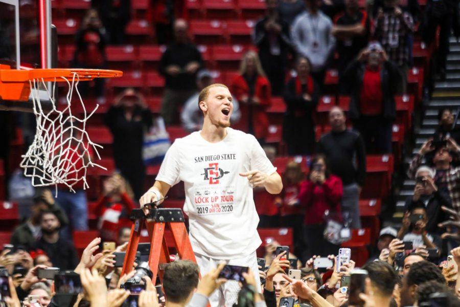 Then-junior guard Malachi Flynn celebrates after cutting down a piece of the hoop following the Aztecs 82-59 win over New Mexico on Feb. 11. The win culminated in the Aztecs claiming the Mountain West Conference regular season title.