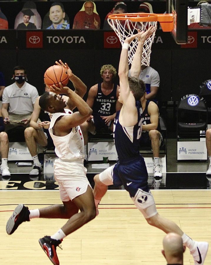 Freshman guard Lamont Butler goes up against a Brigham Young defender during the Aztecs' 72-62 loss to the Cougars on Dec. 18, 2020 at Viejas Arena.