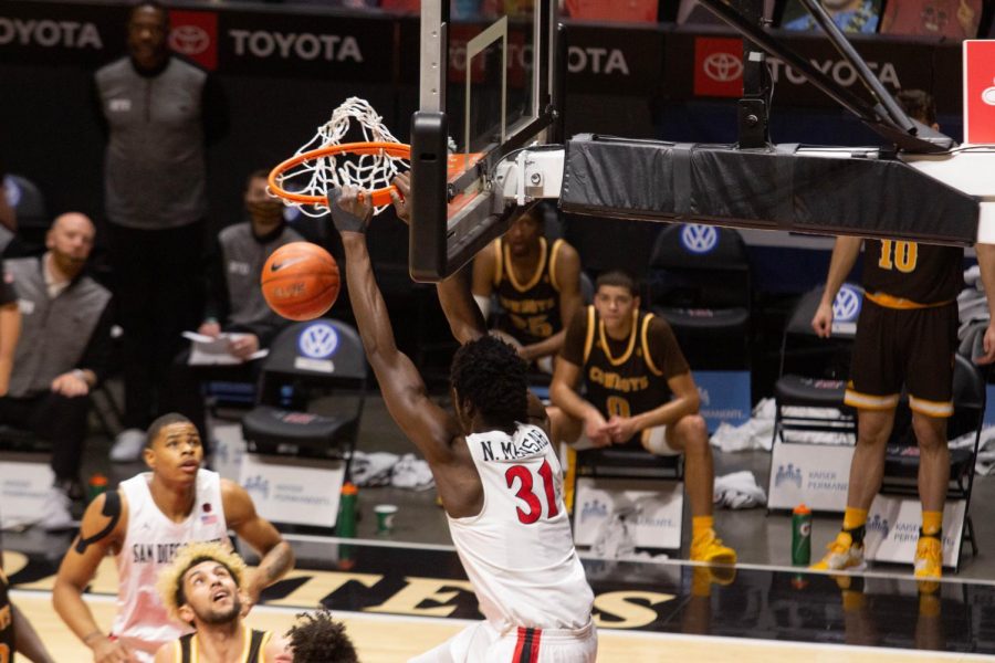 Junior forward Nathan Mensah slams it home during the Aztecs 98-71 win over Wyoming on Jan. 31 at Viejas Arena.