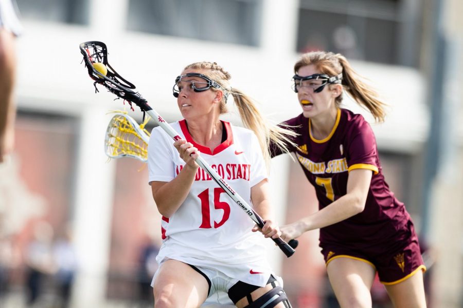 San+Diego+State+lacrosse+then-senior+midfielder+Taylor+Sullivan+looks+to+escape+an+Arizona+State+defender+during+the+Aztecs+19-18+win+over+the+Sun+Devils+on+Feb.+20%2C+2020+at+Aztec+Lacrosse+Field.