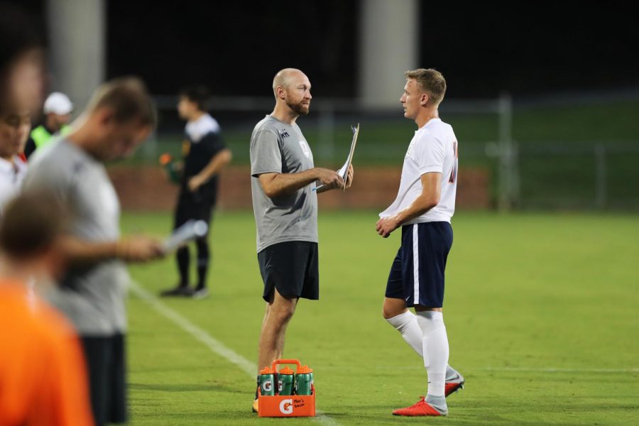 Former Virginia assistant coach Ryan Hopkins (left) instructs a player along the sideline during Hopkins tenure as the Cavaliers head coach. Hopkins was hired as the new head coach of San Diego State mens soccer in January 2020.