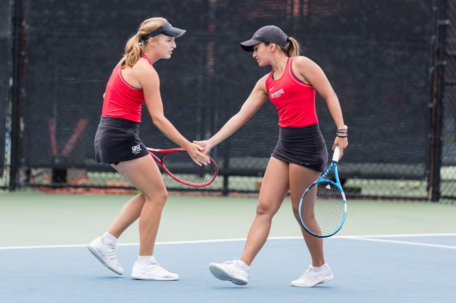 San Diego State womens tennis junior Alicia Melosch (left) high fives senior Tamara Arnold during the Aztecs 4-0 win over Air Force on April 11, 2021 at the Aztec Tennis Center.