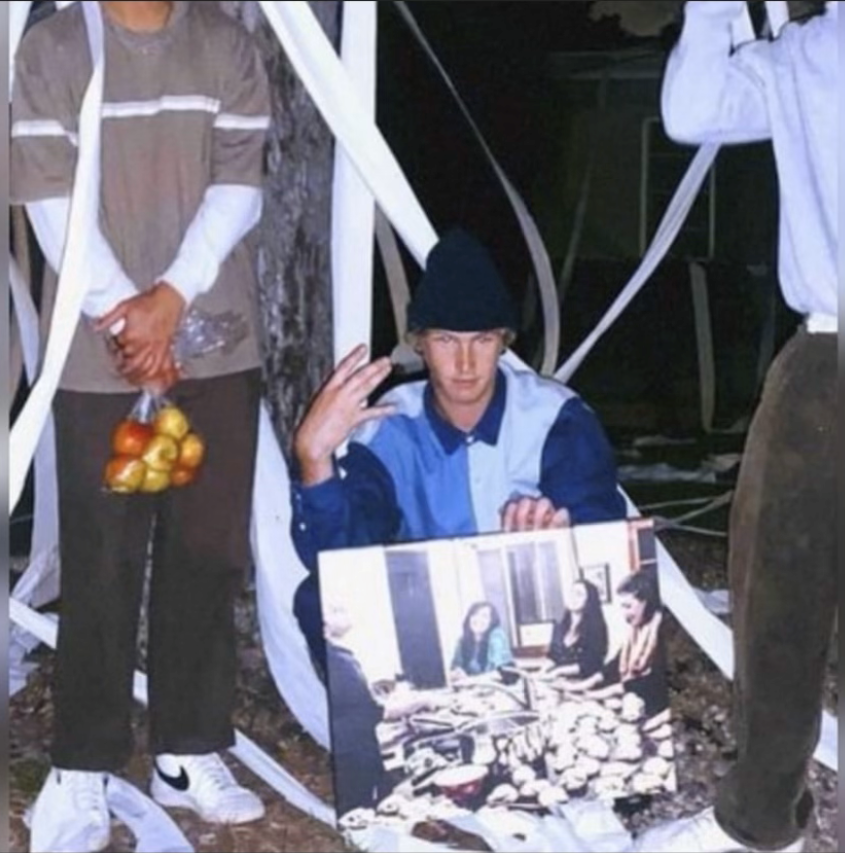 The thieves pose in a photo showing the items they stole from the Chabad House. 