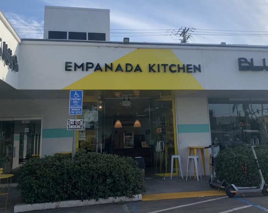 The view of the front entrance of Empanada Kitchen before one enters the modern, yet tiny store. 