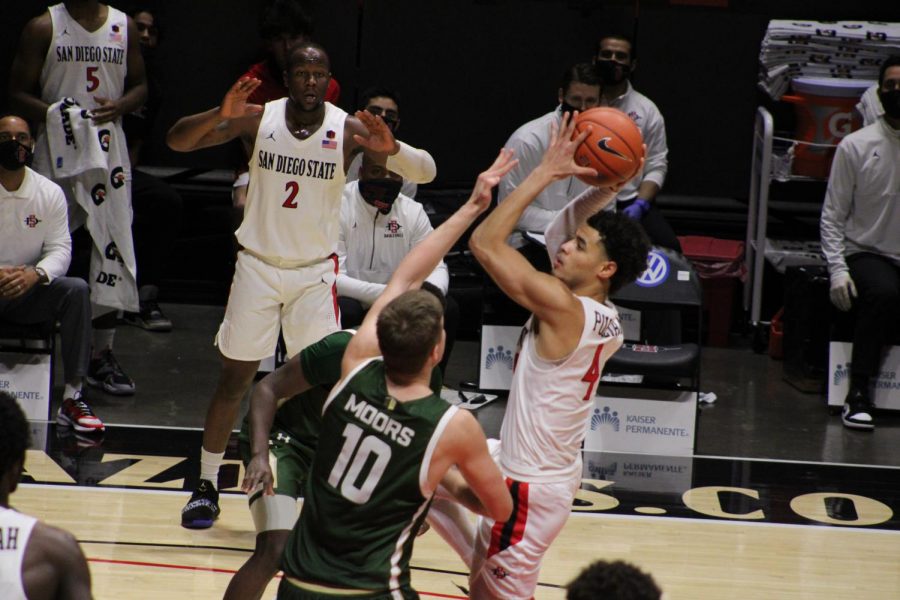 Trey Pulliam (4) pulls up for a shot against Colorado State while Adam Seiko (2) watches on.