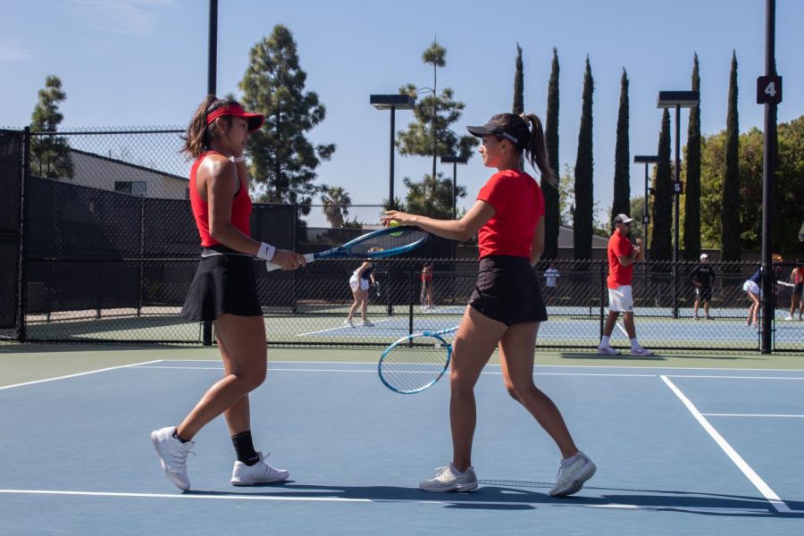 Seniors Bunyawi Thamchaiwat (left) and Tamara Arnold (right) congratulate each other after a set.