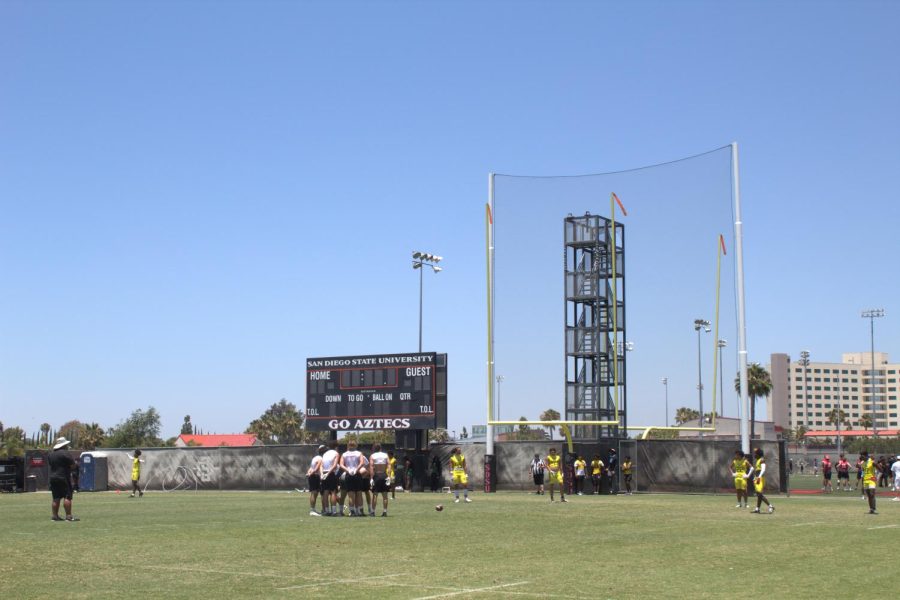 High school football teams face off at the Aztec practice fields during the 7-on-7 football camp