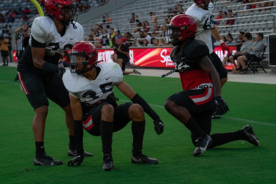 Sophomore cornerback Jelani Whitmore is pulled to his feet after breaking up a pass. The Aztec defense looked strong as a whole. Aug. 20, 2022.