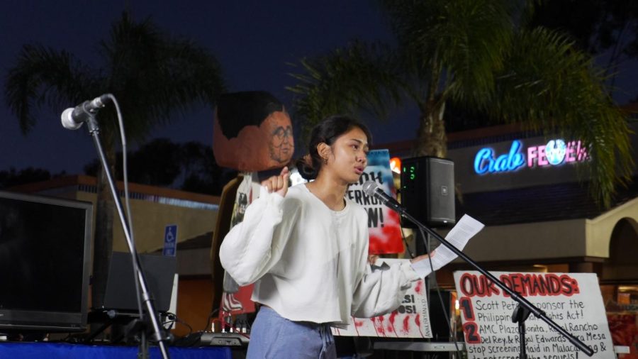 A student speaks to a crowd during the Speak Out for Truth rally at Seafood City.