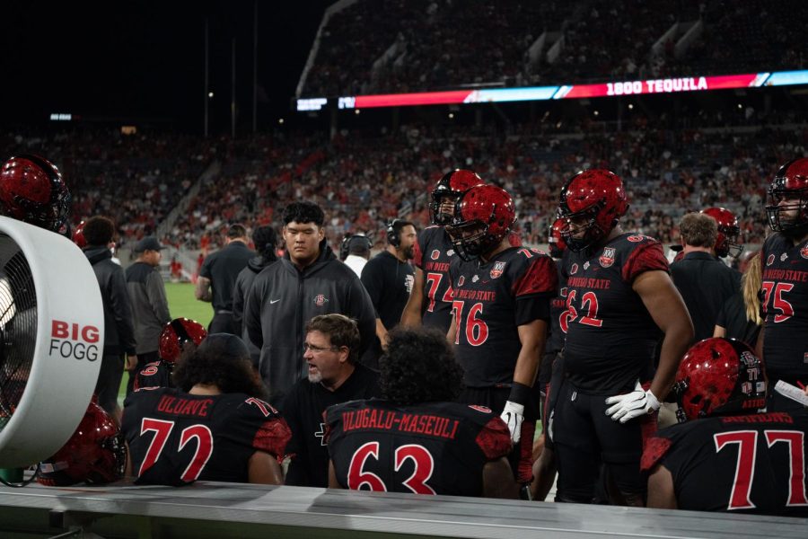 The+Aztec+coaching+staff+meets+with+the+offensive+line+during+a+game+versus+Idaho+State+on+Sept.+10%2C+2022.+