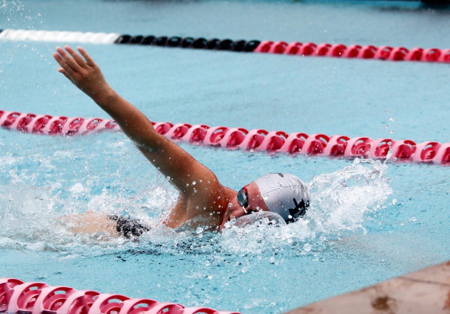 An Aztec swimmer completes a freestyle stroke during warm ups at the first swim event of the season. This meet took place on September 9, 2022, and was held at the Aztec Aquaplex.