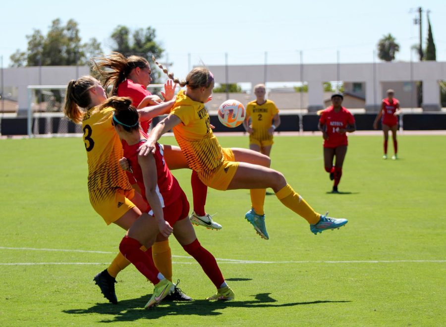 Aztec Womens Soccer players jump up alongside the Wyoming Cowgirls to block the soccer ball on September 25, 2022.