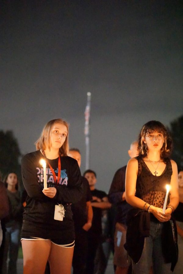 Students hold candles during the vigil.