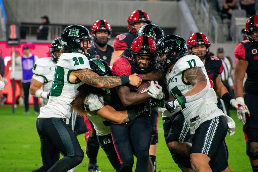 Junior Kenan Christon continues to drive down the field even with four Hawaii players attempting to tackle him during SDSUs victory over Hawaii on Saturday, Oct. 8, 2022.
