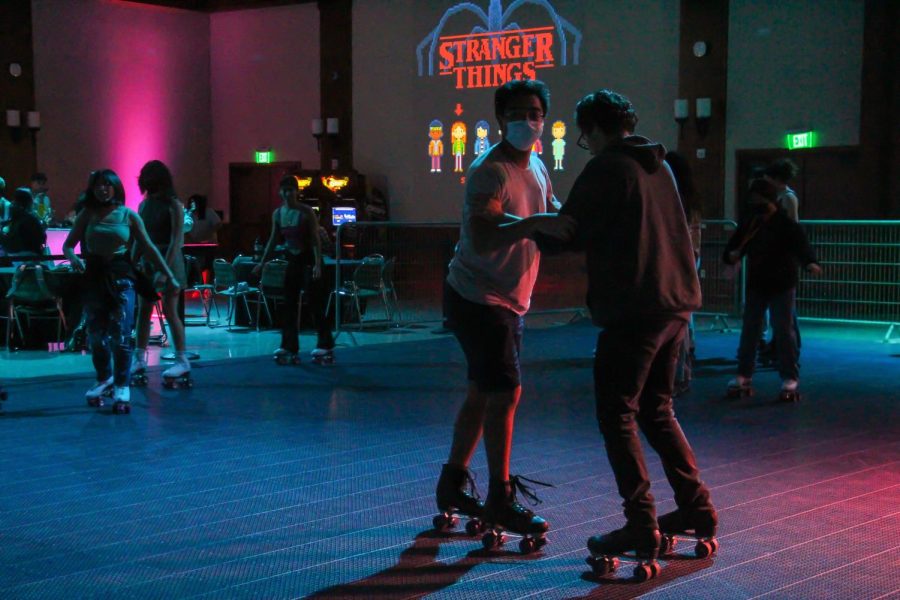 SDSU students hold hands in order to regain their balance on Wednesday,Oct. 5 2022 at the Stranger Things themed event. 