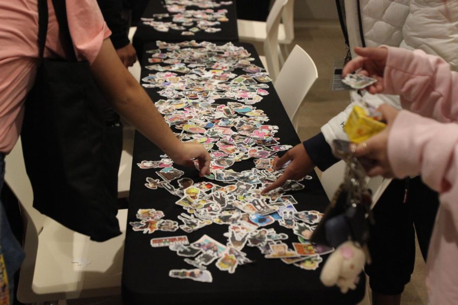 Free anime stickers are offered at the event.