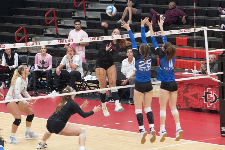 San Diego State junior no. 2 Heipua Tautuaa attacks over Air Force no. 25 Mac Russ and no. 11 Caroline Reinkensmeyer during the second set on Saturday, Oct. 22 at Aztec Court at Peterson Gym in San Diego, Calif. 