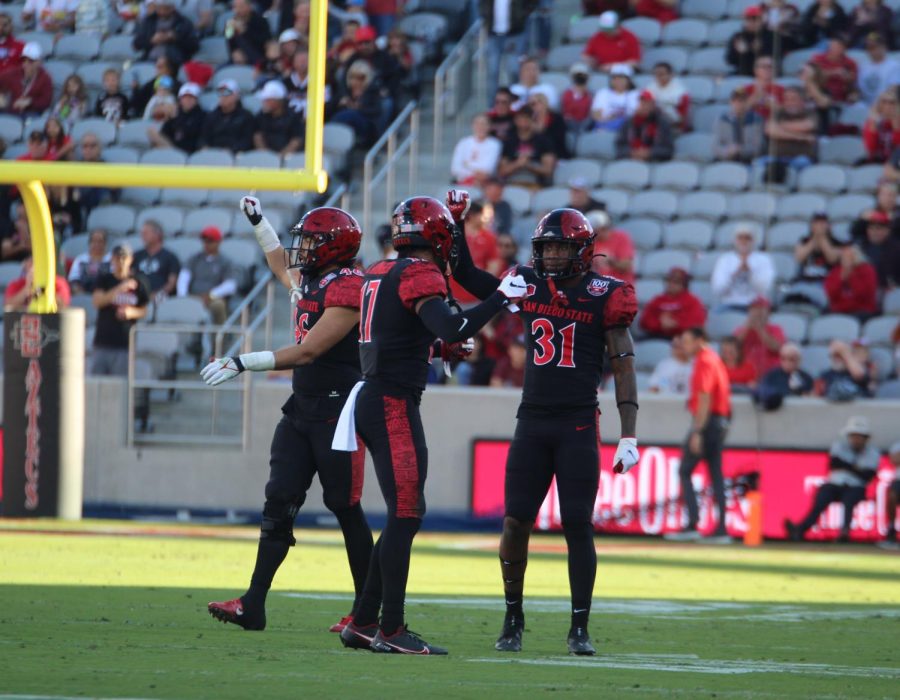 From+left+to+right%2C+senior+linebacker+Michael+Shawcroft%2C+sophomore+cornerback+Noah+Avinger+and+junior+safety+Davaughn+Celestine+celebrate+a+stop+during+a+game+against+UNLV+on+Nov.+5.+