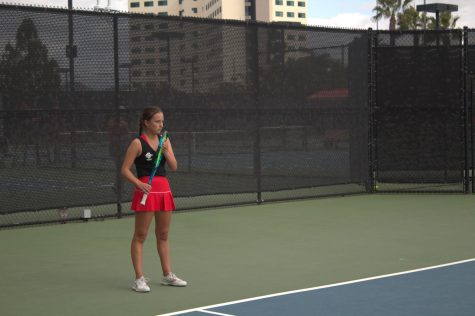 Senior Cécile Morin fixes the strings on her tennis racket during the SDSU Fall Classic II on Nov. 13, 2022.